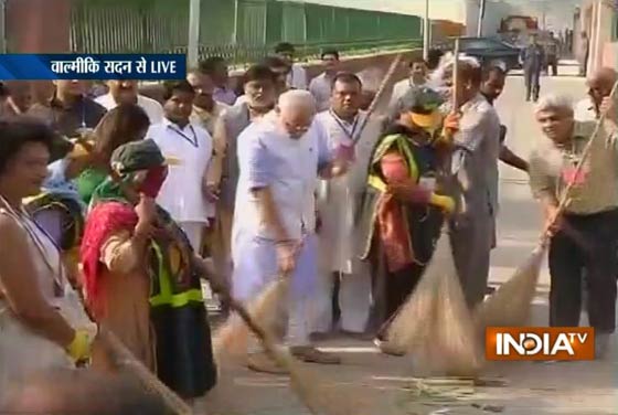 Narendra Modi holds broom