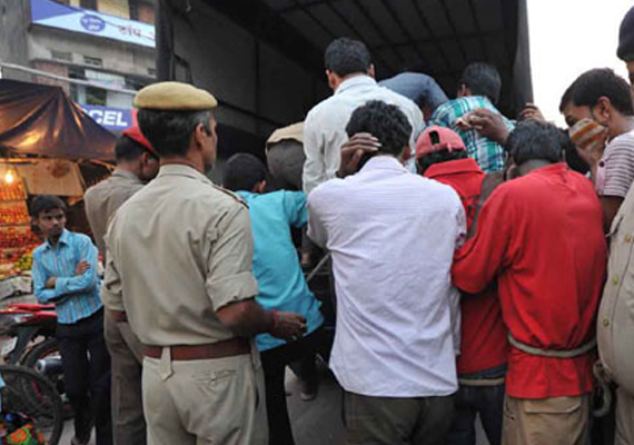 8 gamblers held in a hotel raid